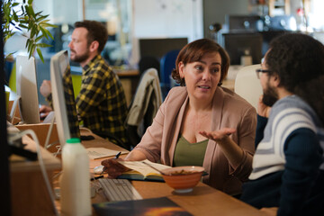 People working at desk, talking