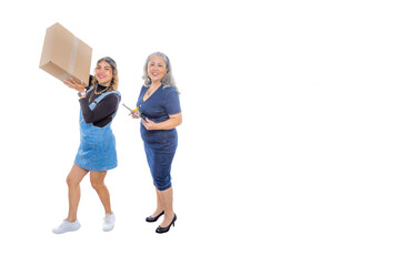 Fototapeta na wymiar Mature woman handing parcel to happy and excited teenage girl with a white studio background, internet shopping in modern age, wide smile, light makeup, casual style, denim clothes. Space for text