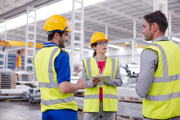 Supervisor and workers talking in steel factory