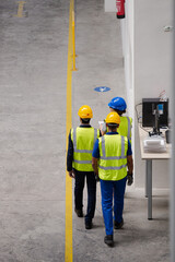 Supervisor and workers walking in factory