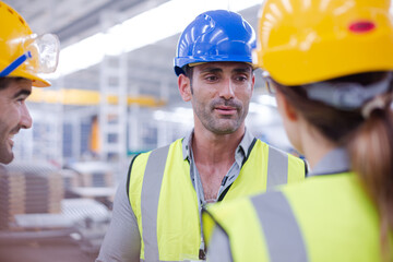 Supervisor and workers talking in steel factory