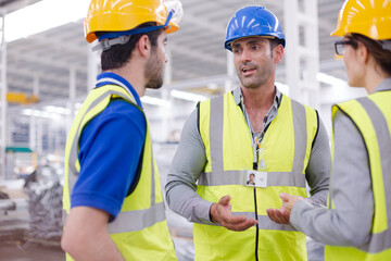Supervisor and workers talking in steel factory