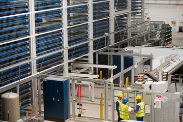 Supervisor and workers talking in factory