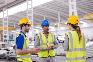 Supervisor and workers talking in steel factory