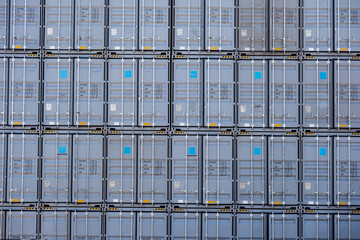 Behind a pile of containers in the deposit yard