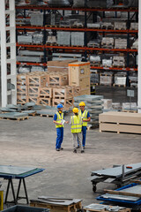 Workers and supervisor talking in factory