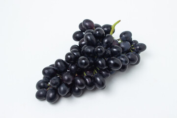 Black grapes on a white background. Fresh juicy grapes