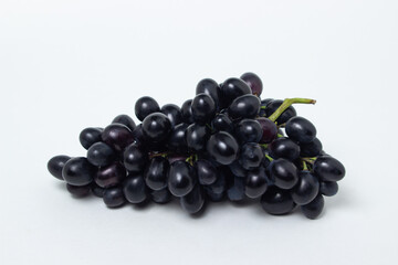 Black grapes on a white background. Fresh juicy grapes