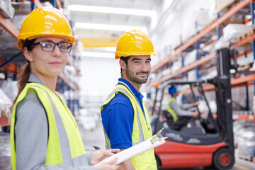 Female supervisor and male worker  talking in factory