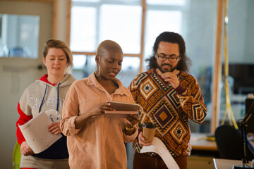 Colleagues talking in office smiling