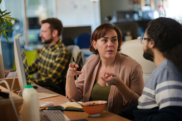 People working at desk, talking