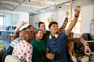 Team taking group selfie in office
