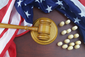 Wooden figures of people, United States flag and judge gavel 
