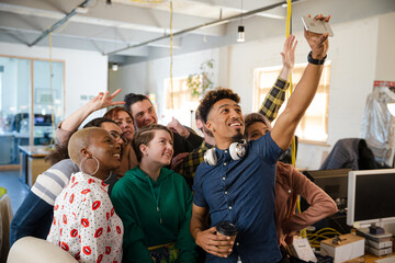 Team taking group selfie in office