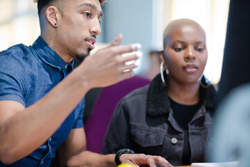 Two colleagues working together at computer