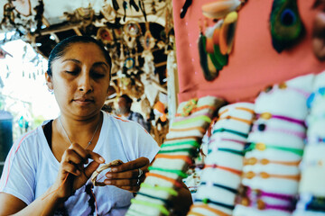 Obraz premium Young female craftswoman concentrating while preparing decoration at shop