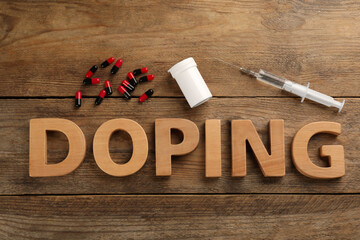 Word Doping and drugs on wooden background, flat lay