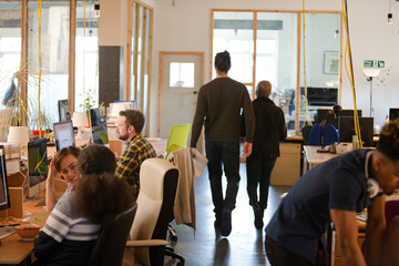 Two colleagues discussing paperwork in office