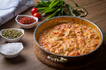 Famous Turkish menemen dinner on table, made by eggs, pepper and tomatoes.