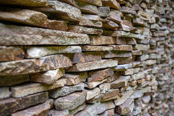The wall is lined with small flat stones. View from the outside.