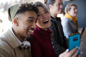 Smiling young couple taking selfie with camera phone