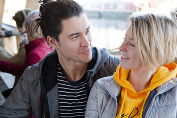 Portrait of smiling couple dining with friends at restaurant outdoor patio