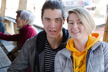 Portrait of smiling couple dining with friends at restaurant outdoor patio