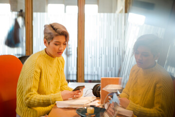 Portrait of young woman working at desk, smiling
