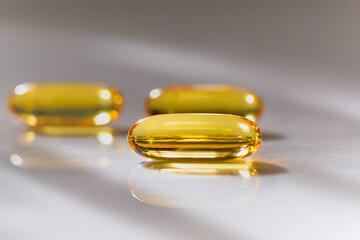 Health care concept close up capsules Omega 3 on blurred background.