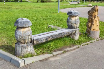 A recreation bench made of wood in a city park in summer sunny day