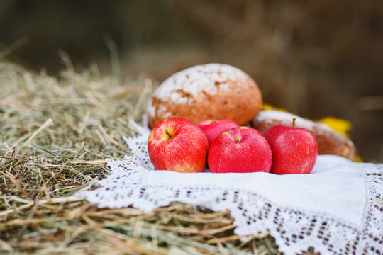 Drevensky still life. Red apples, fresh homemade bread on a white lace napkin. Elements of Russian national cuisine. Horizontal photo.