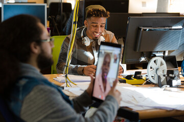 Man sitting at desk using tablet computer