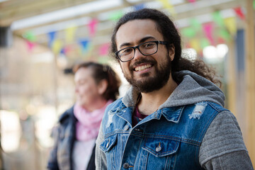 Portrait of smiling young man with beard and long hair