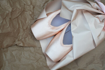 New ballet shoes, pointe shoes lie on a light background. Dancing as an art form