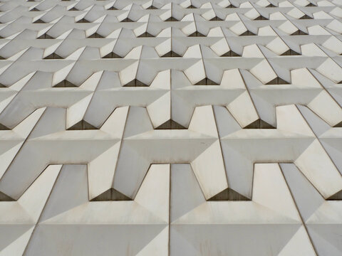 Geometric texture of the gray facade of a building in the city