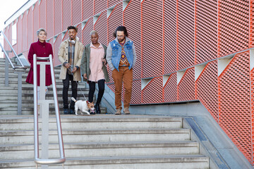 Young friends walking down down urban, modern stairs