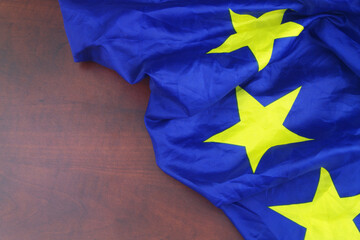 European Union flag on wooden background.