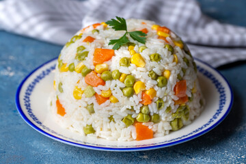 Delicious vegetable rice pilaf with green peas, carrots and sweet corn