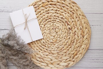 Boho style flat lay composition with round wicker straw mat, letters, pampas grass, top view background with space for text or product. - obrazy, fototapety, plakaty