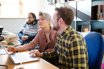 Colleagues working at computer in office