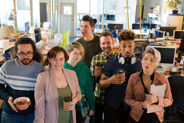 Team posing in office, smiling