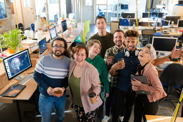 Team posing in office, smiling
