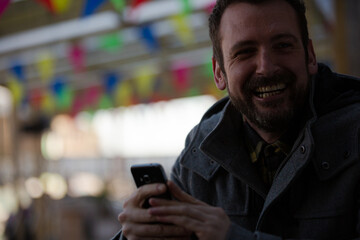 Portrait of smiling man using smartphone