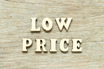 Alphabet letter in word low price on wood background