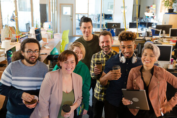 Team posing in office, smiling