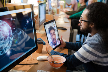 Young man using tablet computer at desk