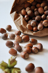 Hazelnut close-up. Hazelnuts in a paper bag on a wooden background. Hazelnut background, healthy food. Corylus. 