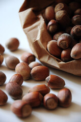 Hazelnut close-up. Hazelnuts in a paper bag on a wooden background. Hazelnut background, healthy food. Corylus. 