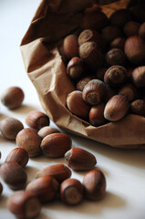 Hazelnut close-up. Hazelnuts in a paper bag on a wooden background. Hazelnut background, healthy food. Corylus. 