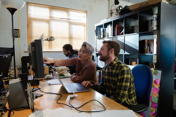 Colleagues working at computer in office